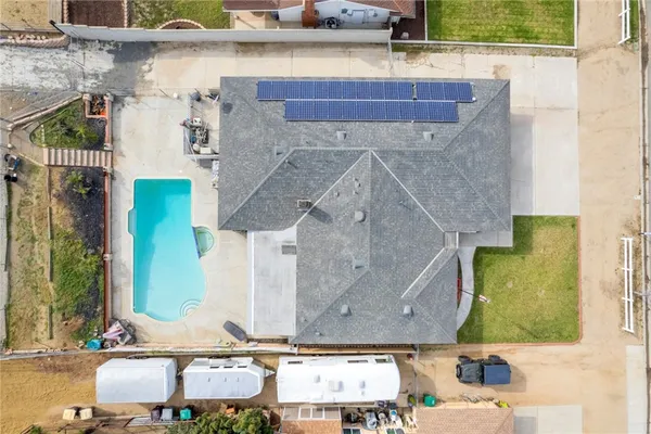 an aerial view of a house with a yard and a fountain