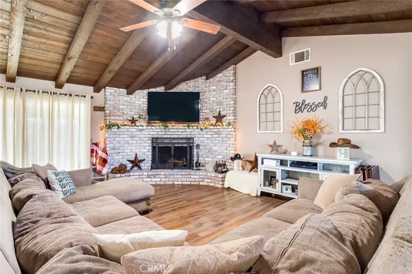 a living room with furniture fireplace and a flat screen tv