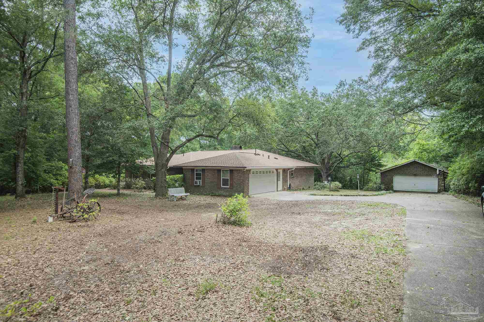1210 Goldenrod Road Cantonment, FL 32533 - Photo 49 of 50 a front view of a house with garden