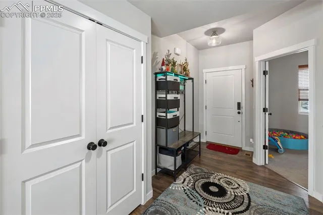 a view of a hallway with wooden floor and stairs