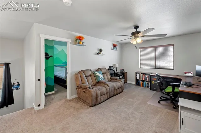 a work room with furniture and a ceiling fan
