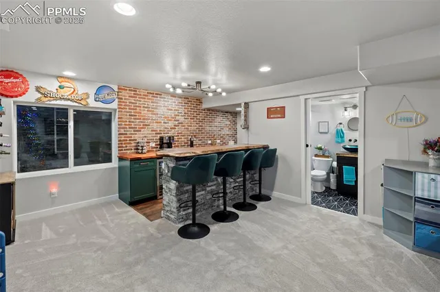 a kitchen with stainless steel appliances kitchen island granite countertop a sink and cabinets