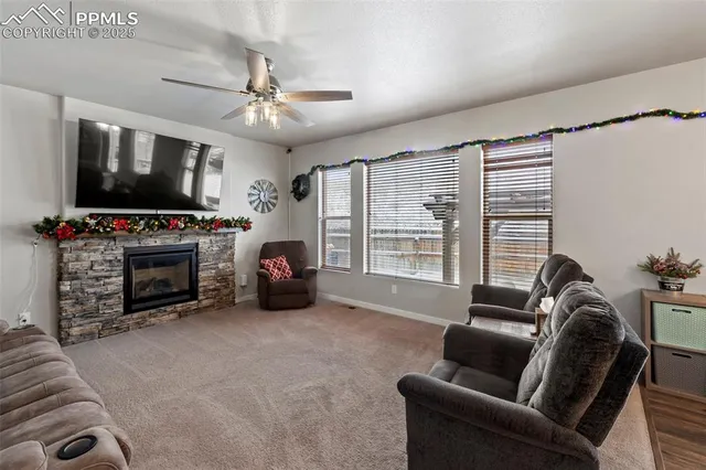 a living room with furniture a flat screen tv and a fireplace