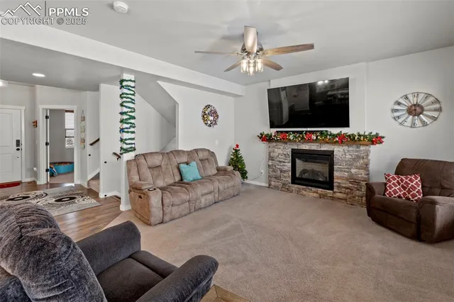 a living room with furniture and kitchen view