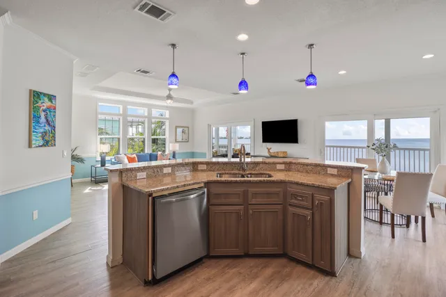 a open kitchen with stainless steel appliances granite countertop a sink and a stove