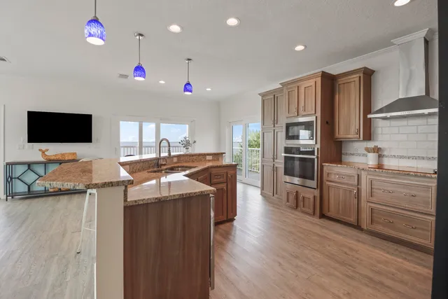 a kitchen with stainless steel appliances granite countertop a stove and cabinets