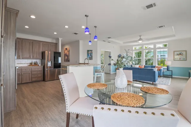 a living room with furniture kitchen and a dining table