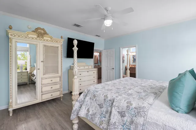 a spacious bedroom with a bed and a flat screen tv