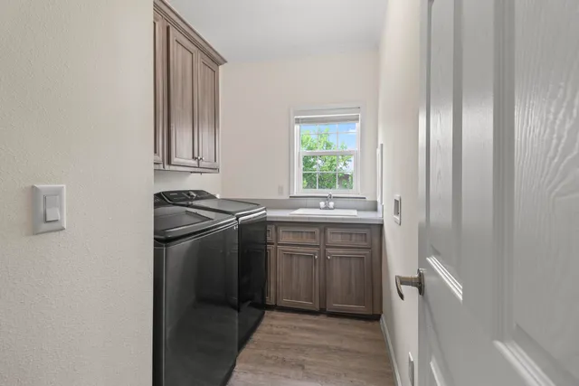 a kitchen with stainless steel appliances granite countertop a sink and a refrigerator