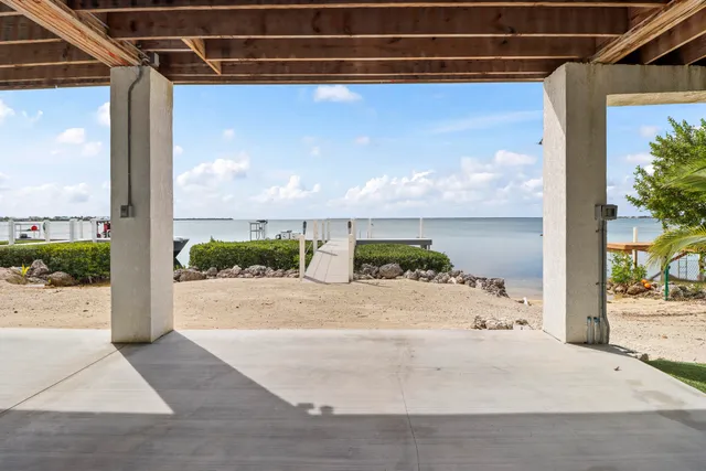 a view of a patio with a table and chairs