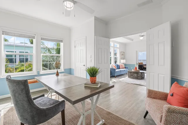 a living room with furniture a wooden floor and a large window