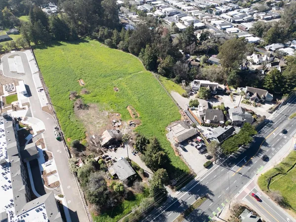 an aerial view of a residential houses with outdoor space