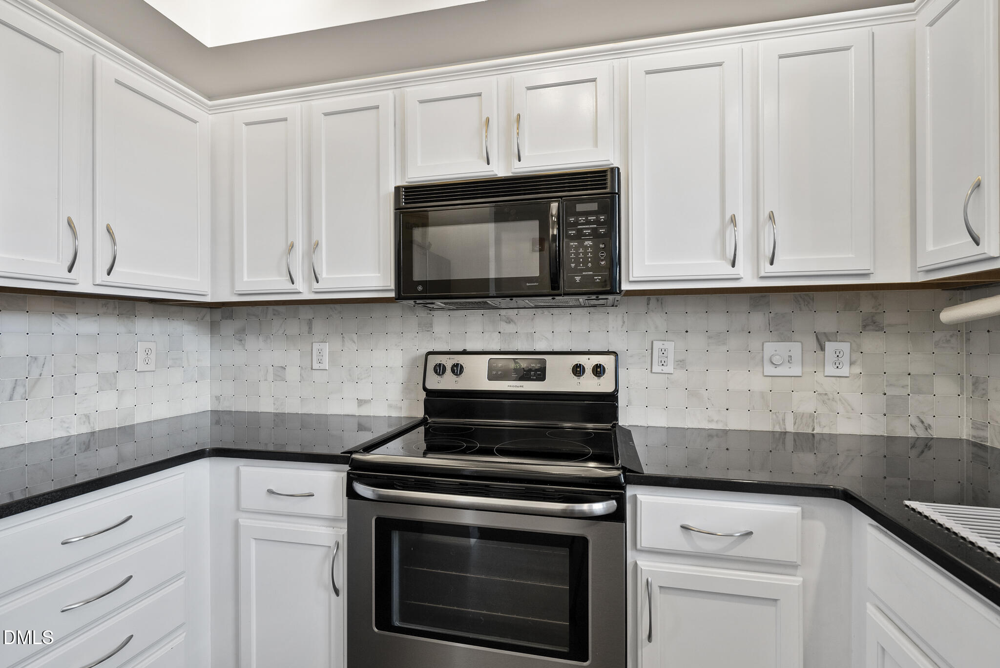 200 South Dawson Street, Unit 111 Raleigh, NC 27601 - Photo 12 of 34 a kitchen with granite countertop white cabinets and stainless steel appliances