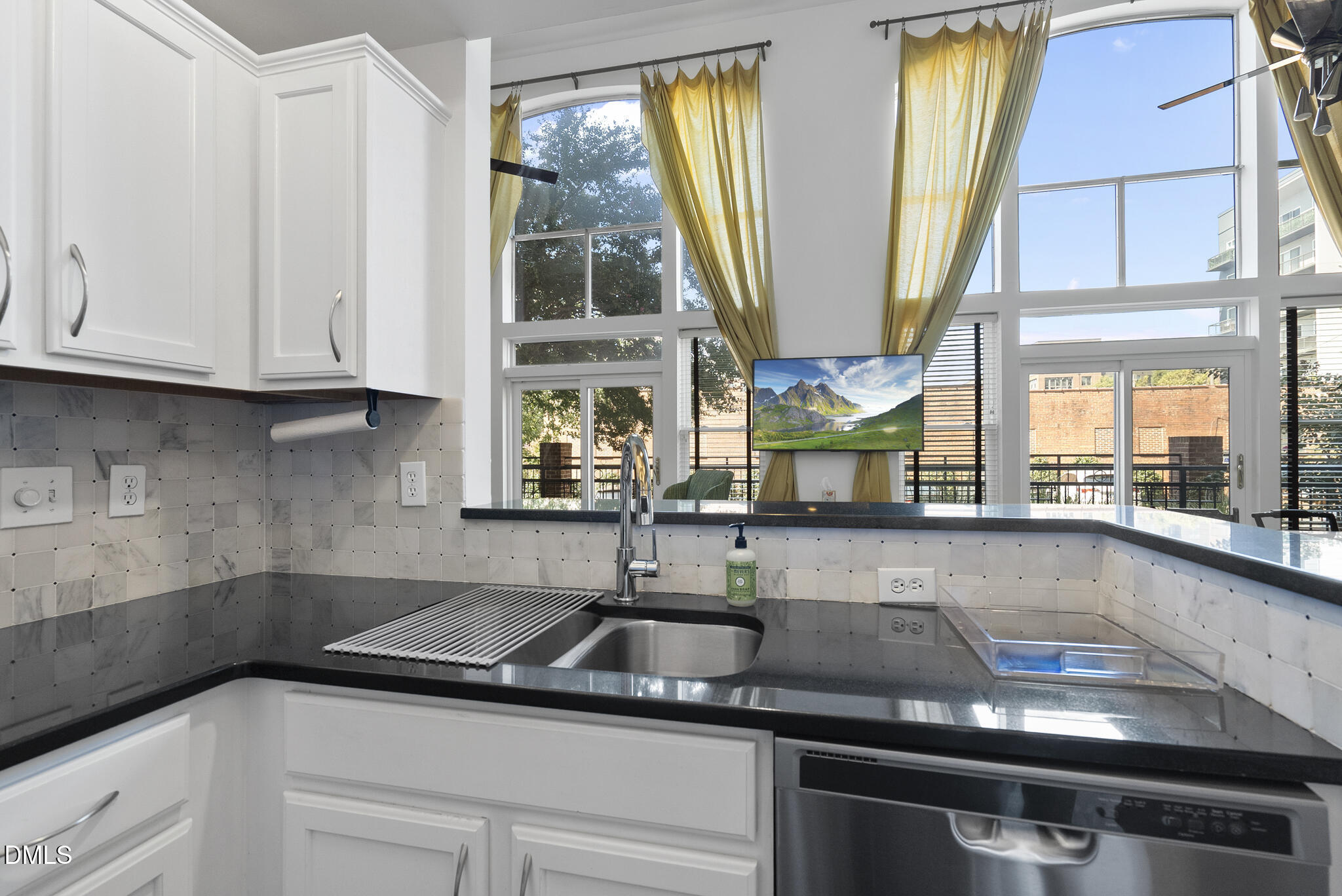 200 South Dawson Street, Unit 111 Raleigh, NC 27601 - Photo 13 of 34 a kitchen with stainless steel appliances granite countertop a sink a window and cabinets