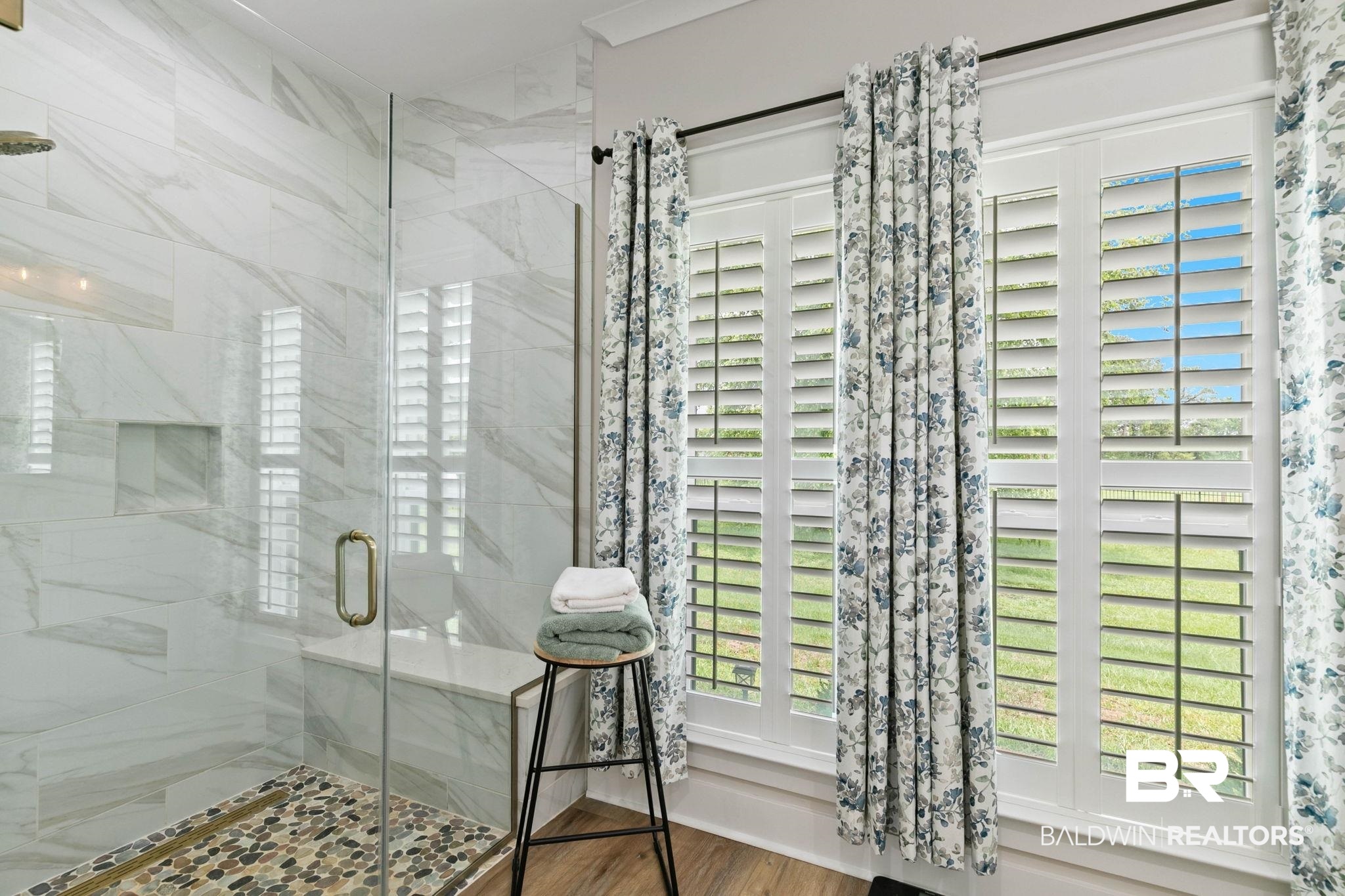 2029 George Lee Road Repton, AL 36475 - Photo 29 of 58 Walk-in shower featuring large format tile, a built-in bench, and a glass enclosure with a gold-finish handle