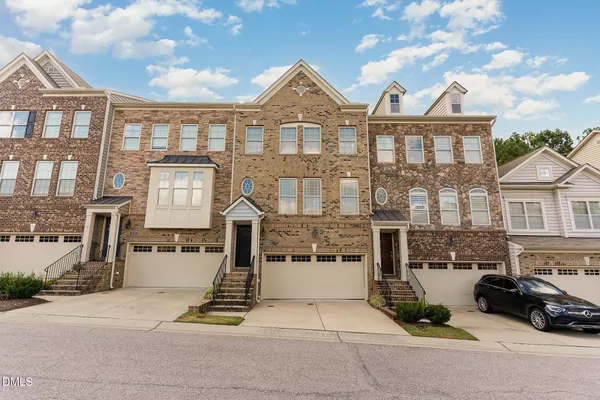 a front view of a residential apartment building with a yard