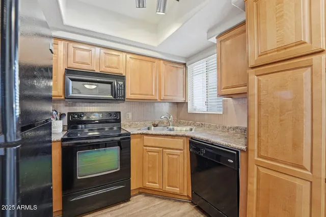 a kitchen with granite countertop cabinets stainless steel appliances and a window