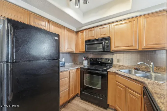 a kitchen with a sink stove and microwave
