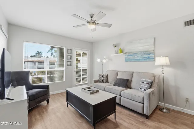 a living room with furniture and a large window