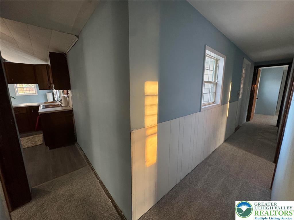 1071 Bitternut Road Walnutport, PA 18088 - Photo 32 of 39 a view of hallway with a large window and wooden floor