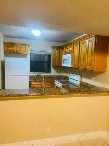 an empty room with wooden floor and closet