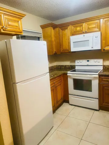 an empty room with wooden floor and a fireplace