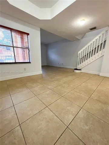 a room with washing machine and window