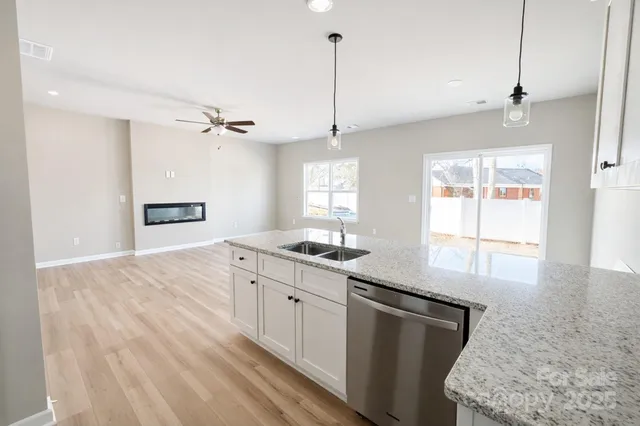 a kitchen with stainless steel appliances granite countertop a sink a stove and a refrigerator