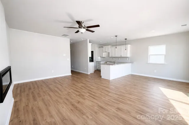 a view of a kitchen with wooden floor and a kitchen