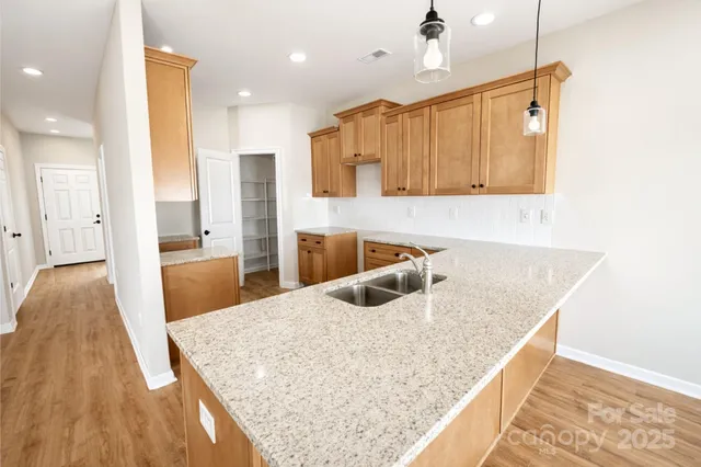 a kitchen with kitchen island a sink and a refrigerator