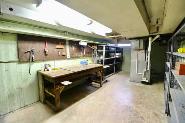 a backyard of a house with barbeque oven table and chairs