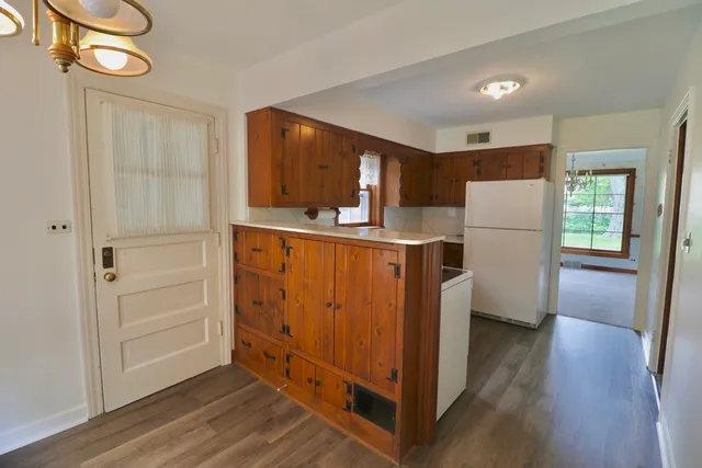 a kitchen with sink cabinets and wooden floor
