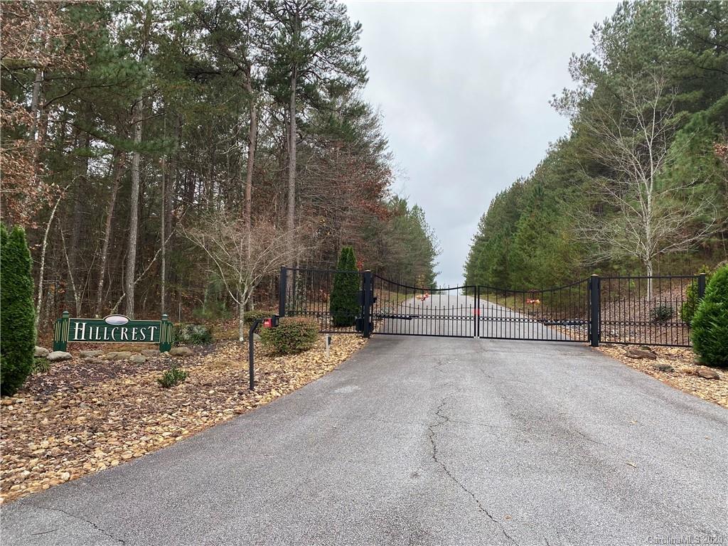 19 Sunset Drive Mill Spring, NC 28756 - Photo 6 of 7 a view of a park that has large trees and a wooden fence