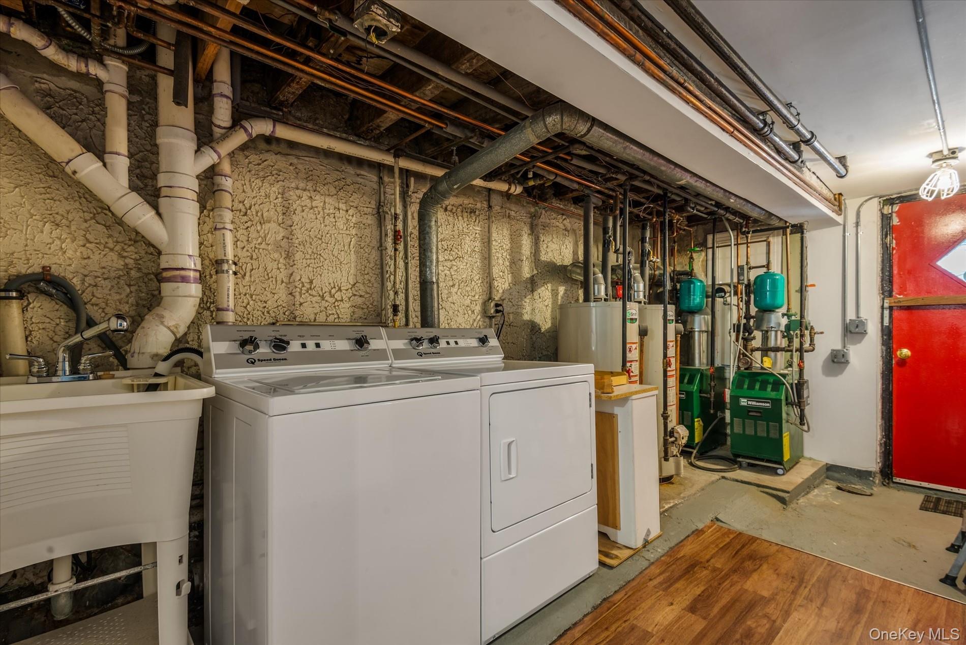 26-19 14th Place Queens, NY 11102 - Photo 31 of 33 Laundry room featuring independent washer and dryer, water heater, and a heating unit