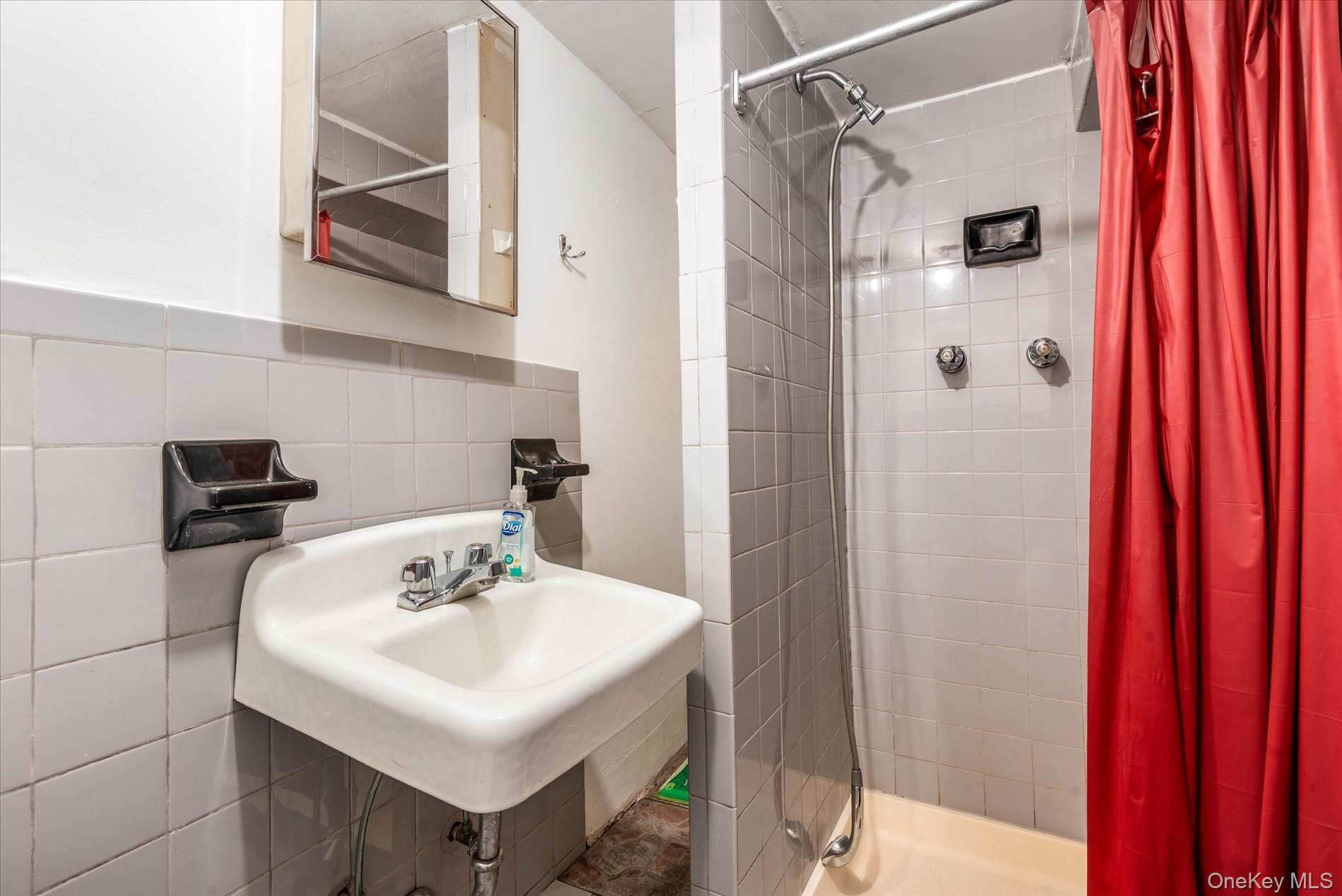 26-19 14th Place Queens, NY 11102 - Photo 33 of 33 Full bath with a stall shower and tile walls