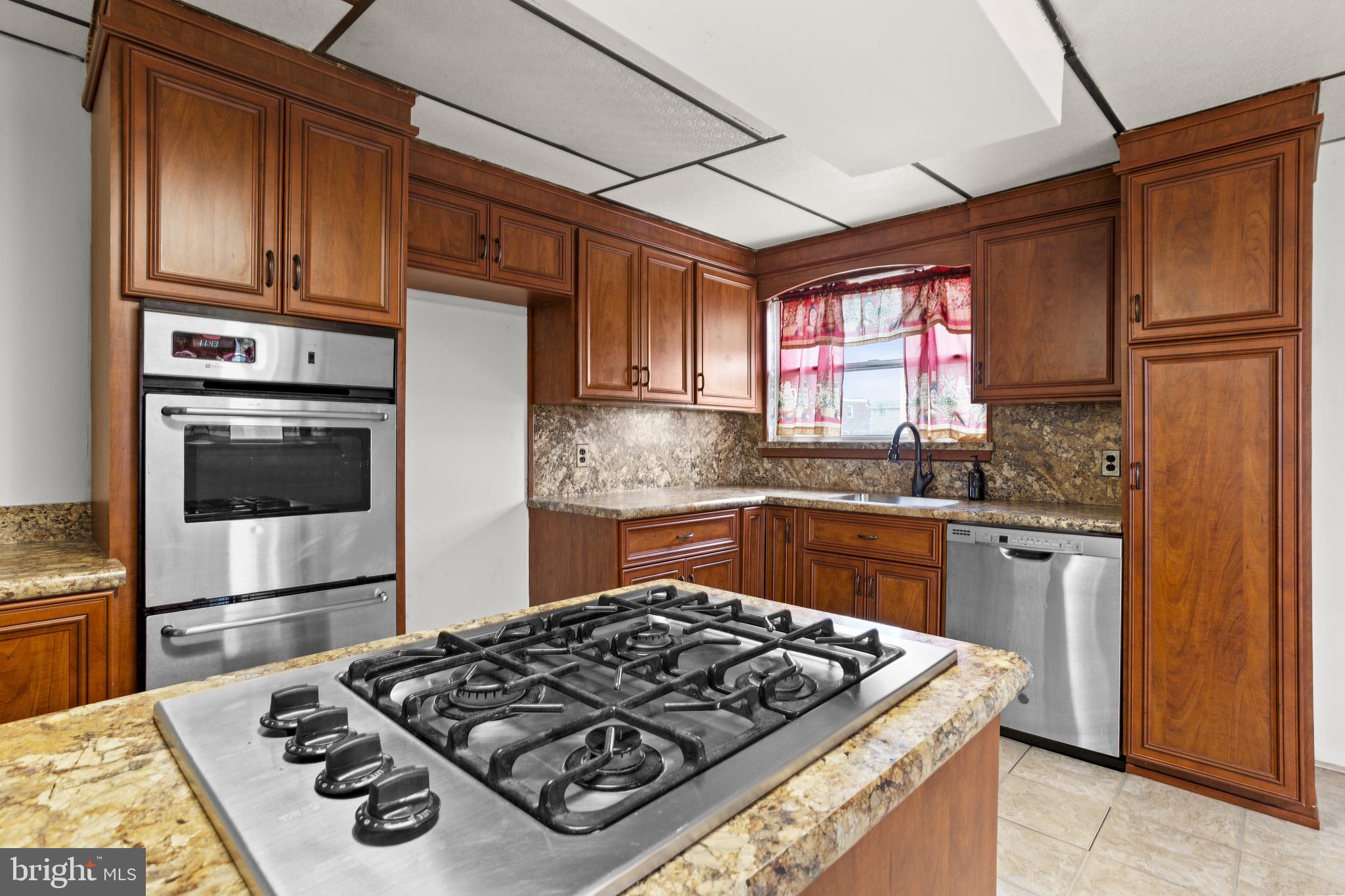 1900 Fowler Road Folcroft, PA 19032 - Photo 11 of 24 a kitchen with stainless steel appliances granite countertop a stove refrigerator sink and cabinets