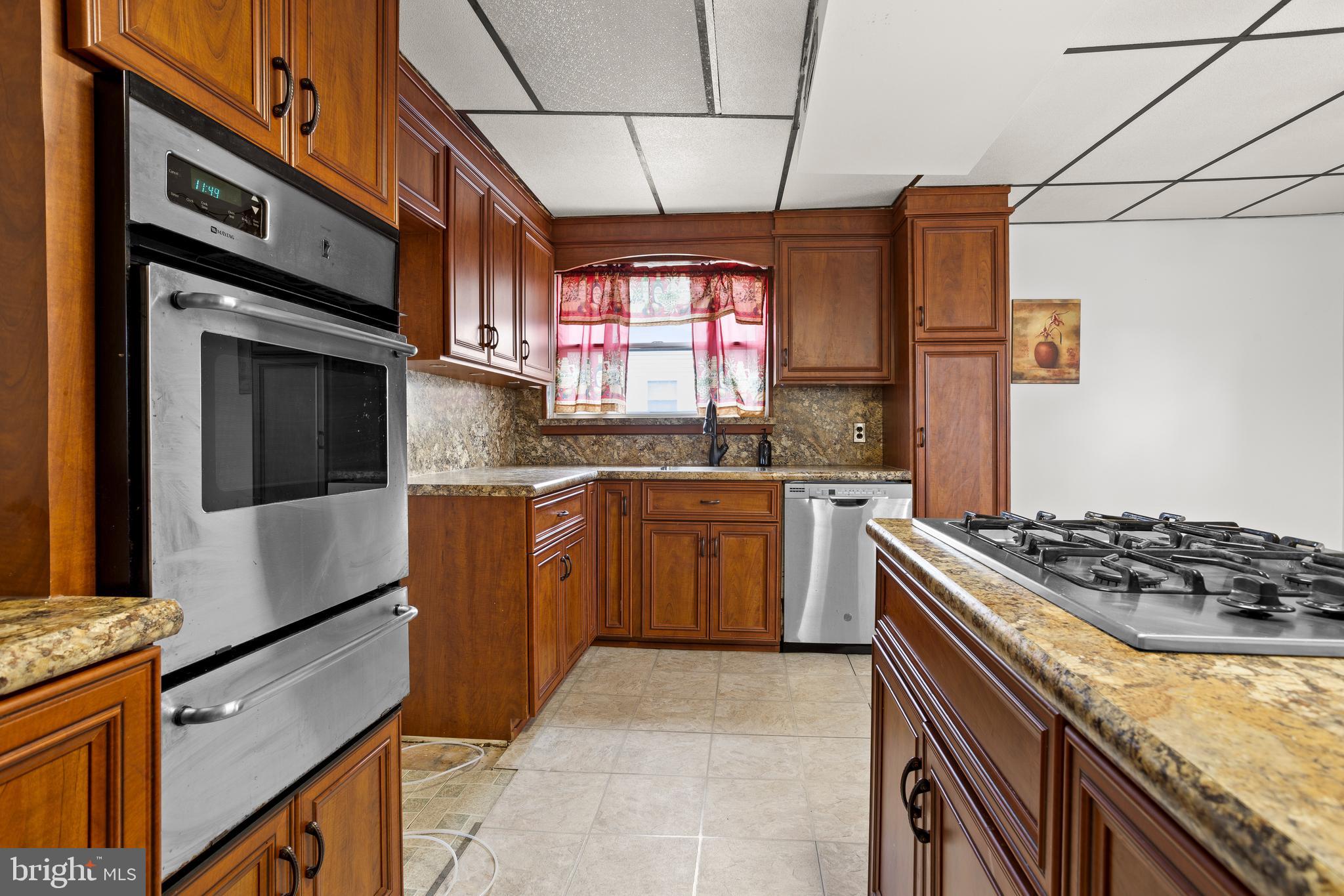 1900 Fowler Road Folcroft, PA 19032 - Photo 12 of 24 a kitchen with stainless steel appliances granite countertop a stove sink and cabinets
