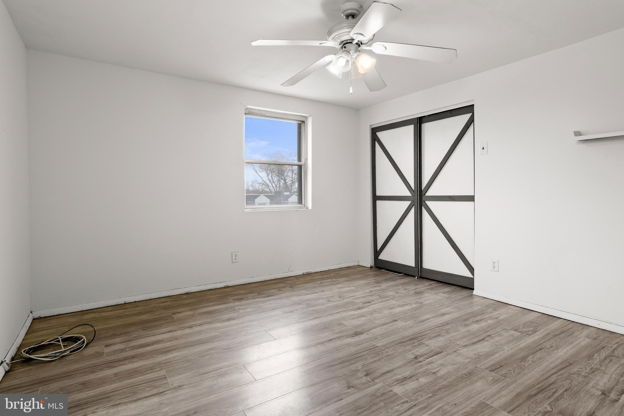 1900 Fowler Road Folcroft, PA 19032 - Photo 15 of 24 a view of an empty room with a window and wooden floor