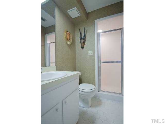 3415 Clark Avenue Raleigh, NC 27607 - Photo 9 of 20 a bathroom with a toilet a sink and a shower