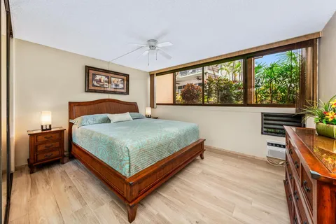a bedroom with a bed and a large window