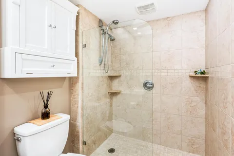 a bathroom with a shower a toilet and sink