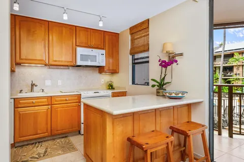a kitchen with stainless steel appliances kitchen island granite countertop a sink and cabinets