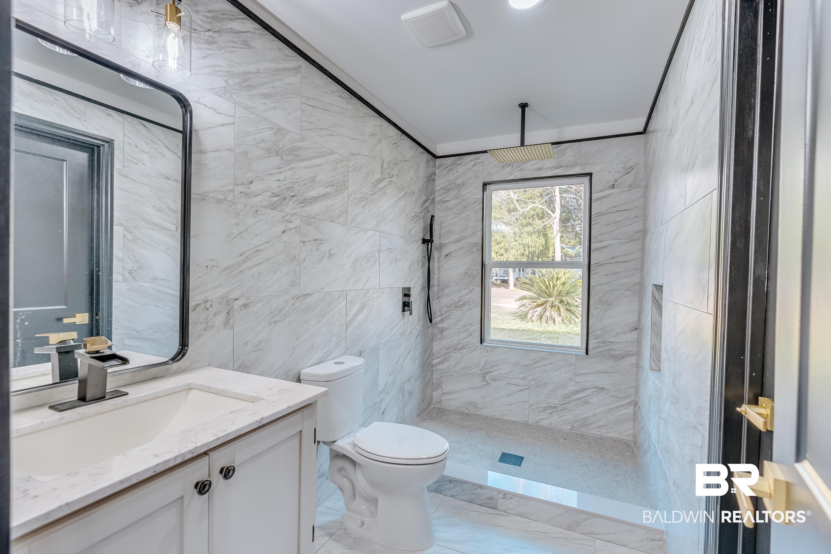1190 Military Road Mount Vernon, AL 36560 - Photo 21 of 47 Full bathroom with tile walls, a marble finish shower, vanity, light marble finish flooring, and ornamental molding