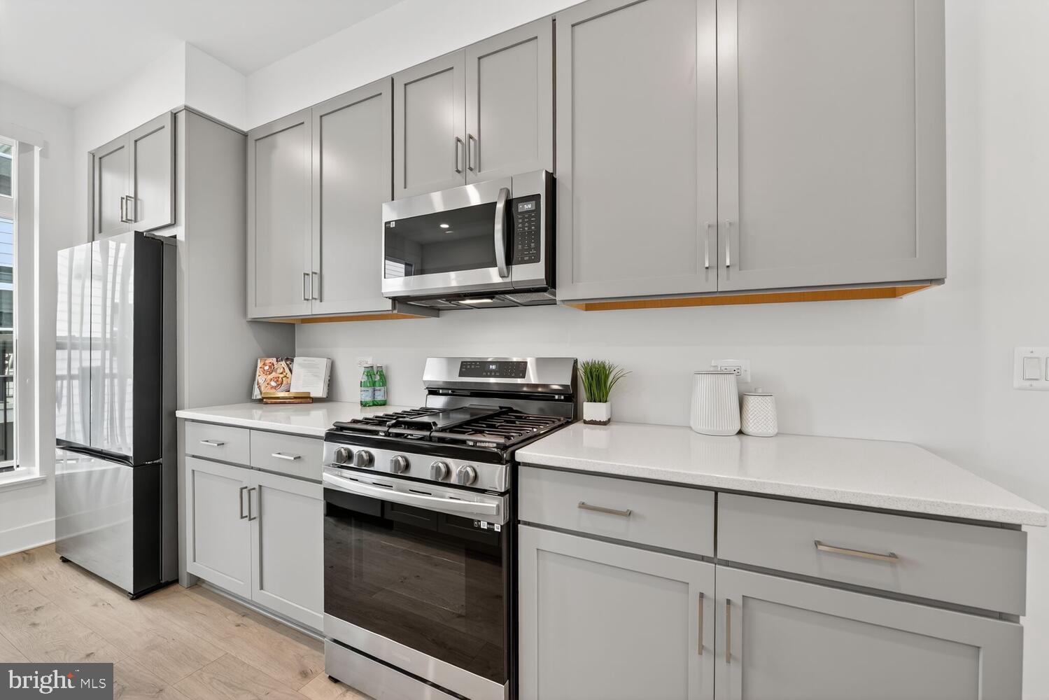 2009 Tysons Ridgeline Road Falls Church, VA 22043 - Photo 15 of 64 a kitchen with stainless steel appliances granite countertop white cabinets and a stove a refrigerator a sink