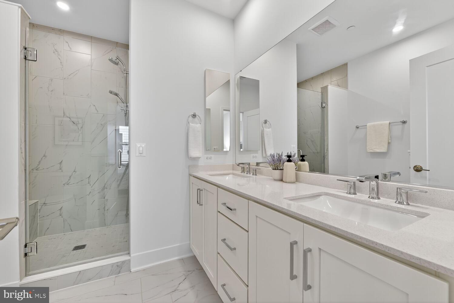 2009 Tysons Ridgeline Road Falls Church, VA 22043 - Photo 23 of 64 a bathroom with a double vanity sink mirror and shower