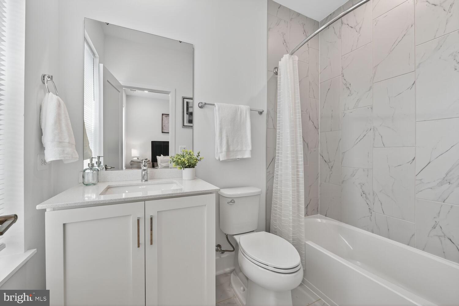 2009 Tysons Ridgeline Road Falls Church, VA 22043 - Photo 28 of 64 a bathroom with a granite countertop sink toilet and shower