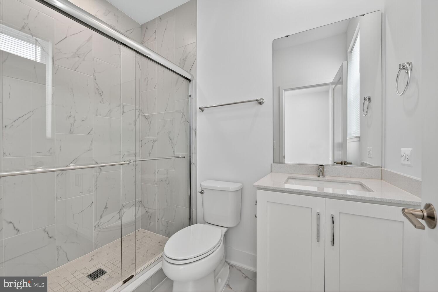 2009 Tysons Ridgeline Road Falls Church, VA 22043 - Photo 39 of 64 a bathroom with a granite countertop sink toilet and shower