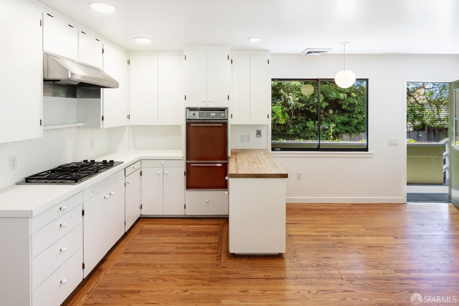 38 Sunset Drive Berkeley, CA 94707 - Photo 12 of 21 a kitchen with sink a microwave and cabinets