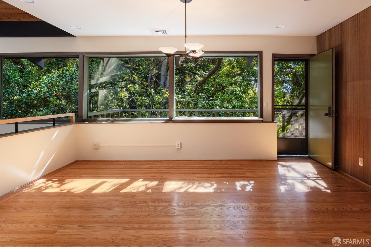 38 Sunset Drive Berkeley, CA 94707 - Photo 10 of 21 a view of an empty room with wooden floor and a window