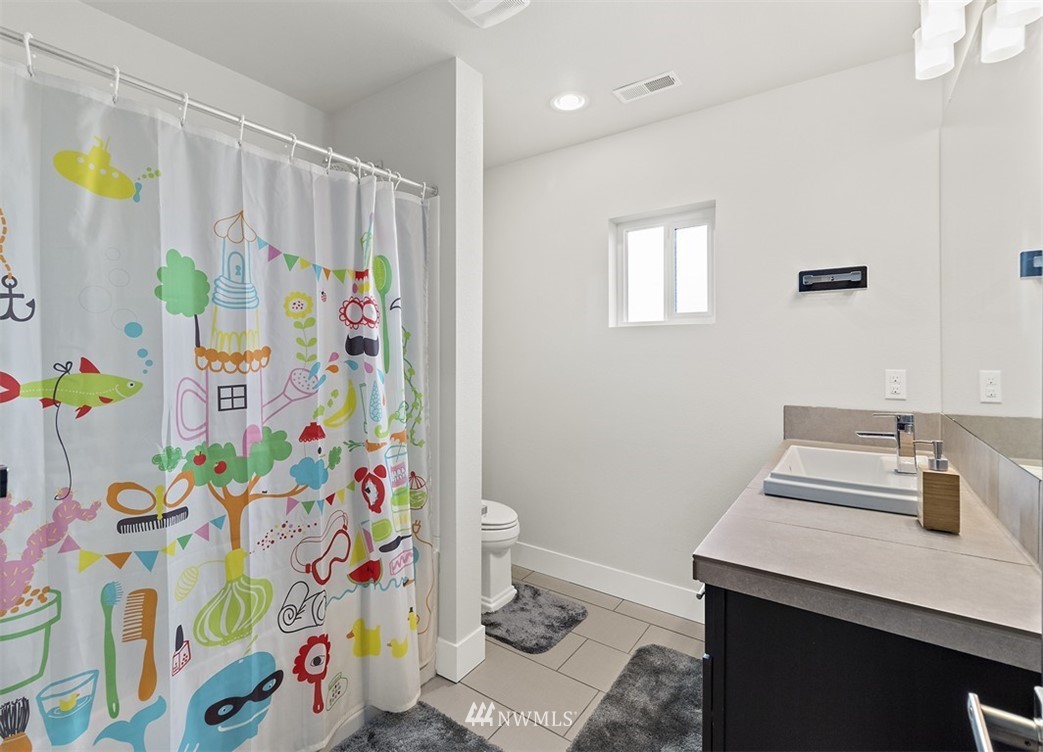 20515 3rd Avenue Southeast, Unit 14 Bothell, WA 98012 - Photo 14 of 20 a bathroom with a sink a toilet and shower curtain